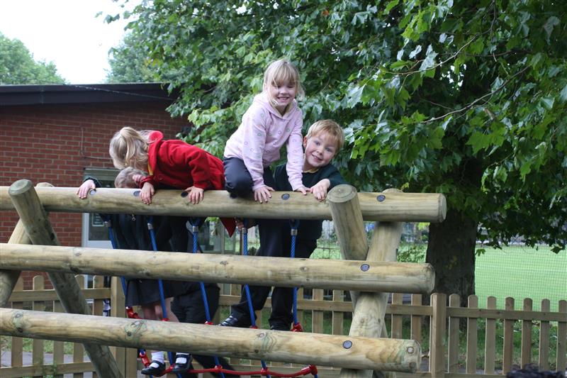 Children outdoors climbing 