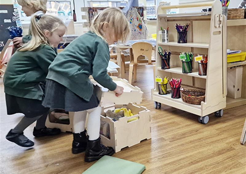 School children using storage inside Stack and Sit Stools.