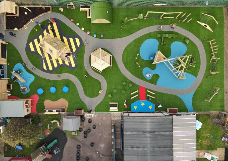 birdeye view of our wetpour surfacing made to look like a roadway with bright wetpour features also added