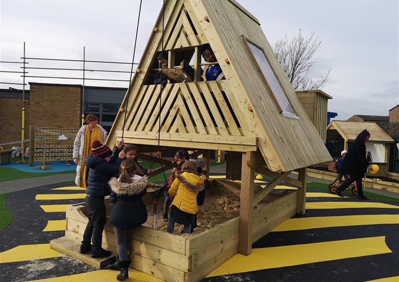 A class of children playing in their investigative tree 