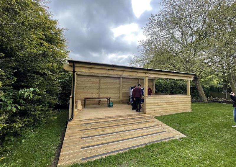 a side view of the gable end, there is a ramp going up one side of the gable end and a window on the other side.
