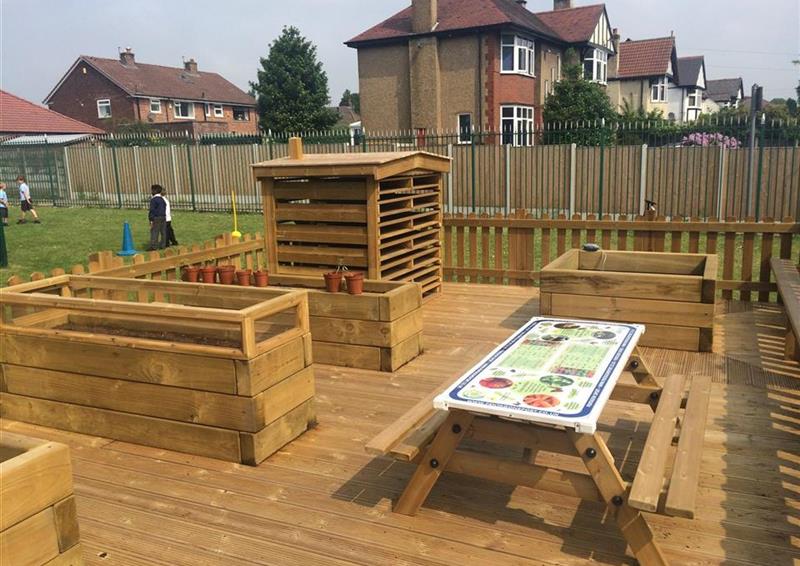 A picture of an outdoor area filled with nature and planting products, there are no children within this picture.