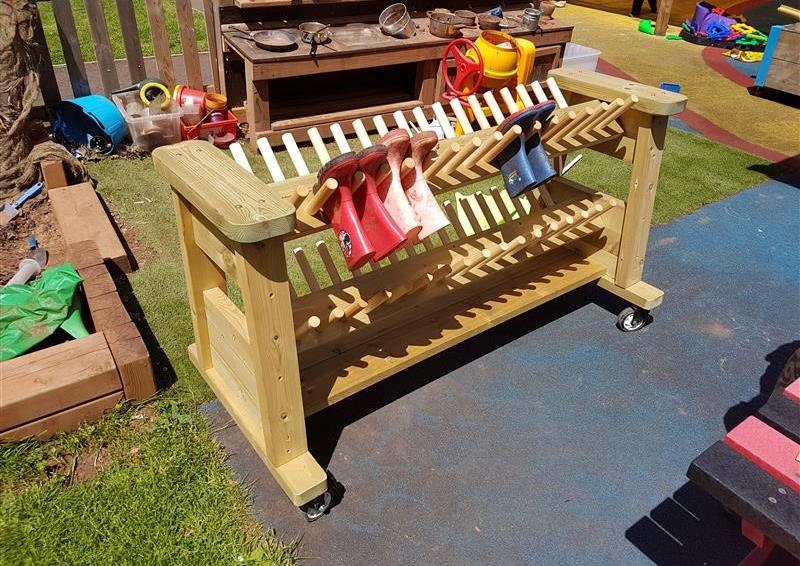 the timber welly rack showing multi-coloured wellies
