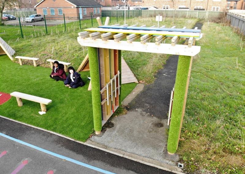 a birdseye vew of our sensory arbour near real grass and perch benches to the left