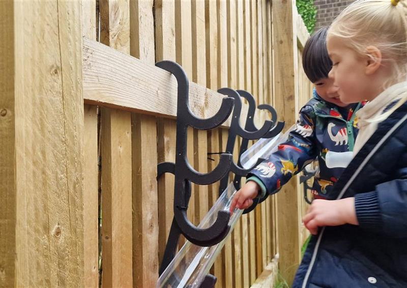2 young children pouring water down the water channels