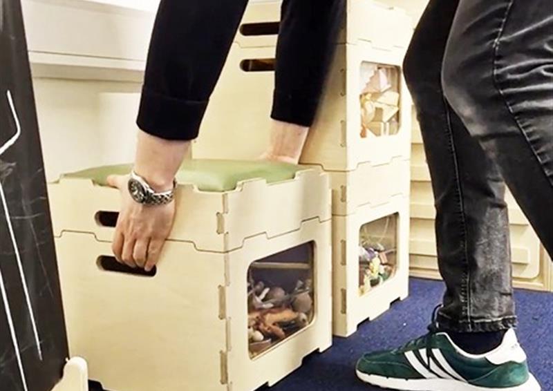 Stack and Sit Stool being picked up.