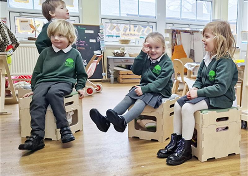 School children sat on Stack and Sit Stools.