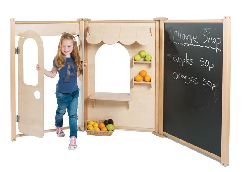 A young girl is playing with the Maple Panel Shop Set, she is pretending to sell apples and oranges. 