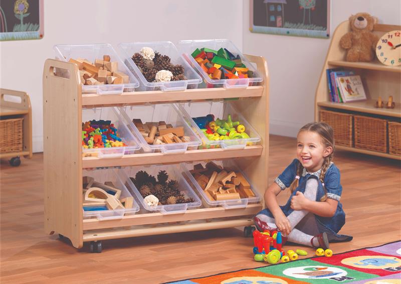 The Tilt Tote Storage with 9 Clear Tubs is full of different resources, a young girl is playing next to it in the classroom