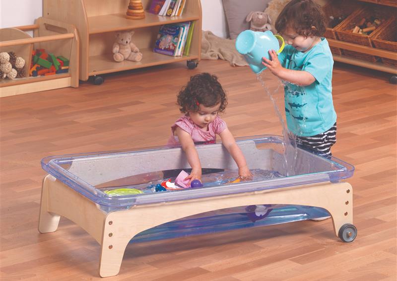 Two toddlers are playing with the Sand & Water Station in a classroom