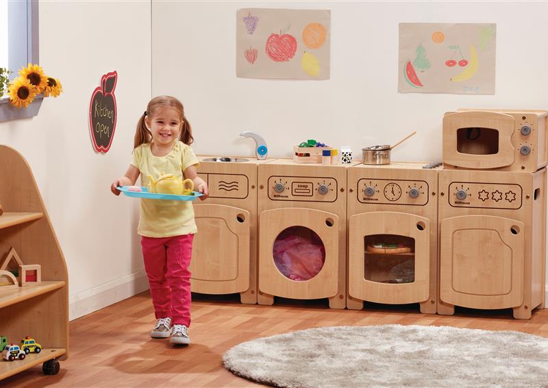 A young girl using the Stamford Kitchen Set including a Microwave, Sink, Fridge, Washer & Cooker